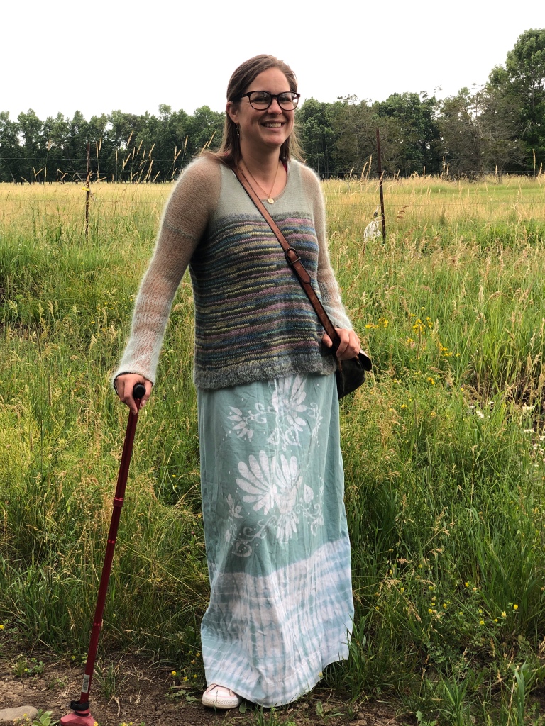 This is a recent photo of me standing in a field, wearing my favourite outfit: a lightweight sweater I made and a refashioned dress I’ve had since high school that always fits me because it’s basically a giant sack.  